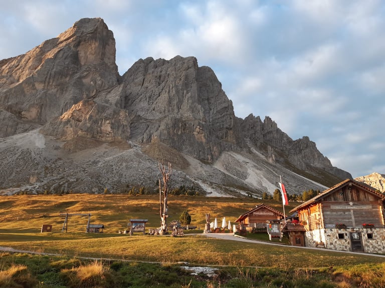 Mountain path leading to alpine hut with scenic views
